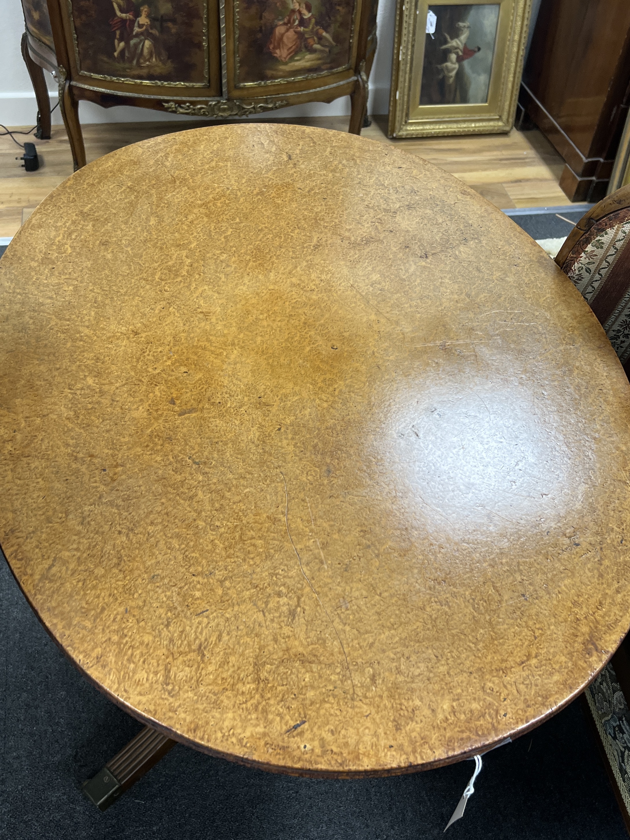 A George III bird's eye maple oval tilt top tea table, width 90cm, depth 68cm, height 71cm